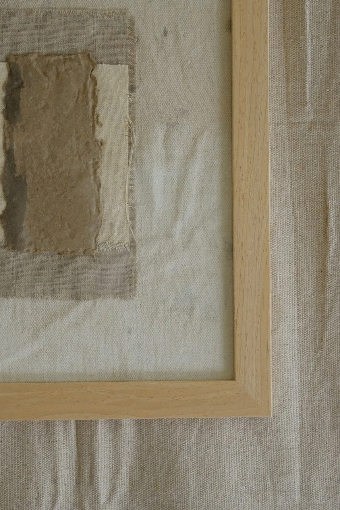 Framed 11 x 14 collage of textured brown paper layered over ivory canvas and grey linen
