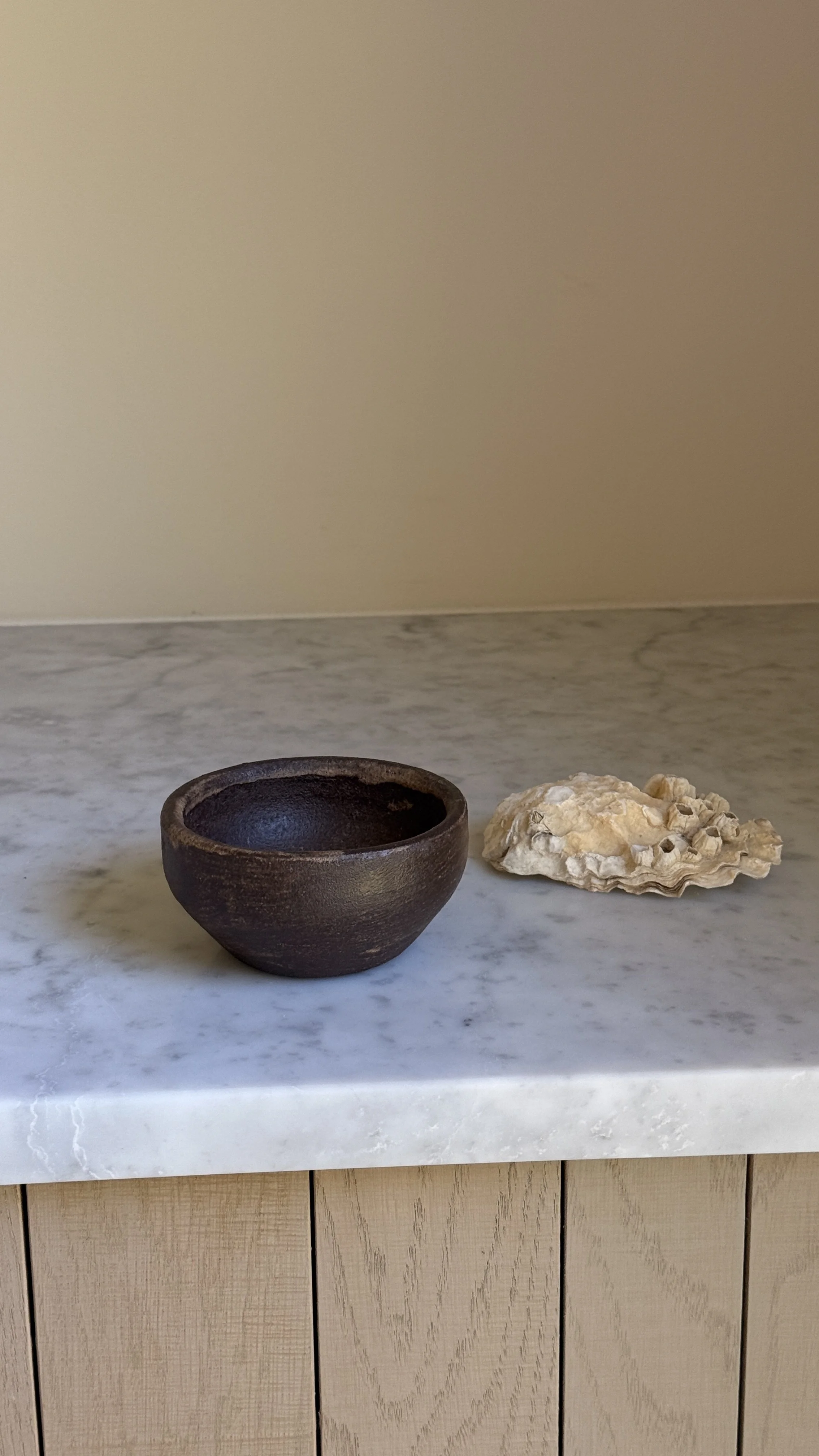 IMG_7024.jpegDark brown ceramic bowl with horizontal brushed texture and warm bronze highlights, tapered base