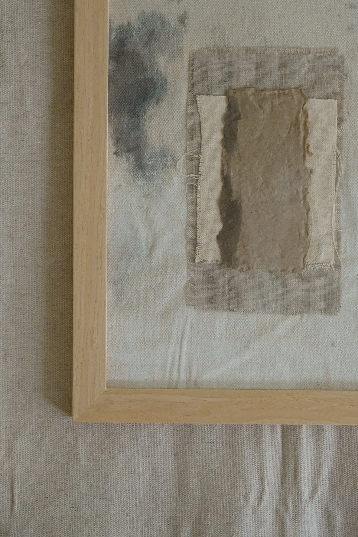 Framed 11 x 14 collage of textured brown paper layered over ivory canvas and grey linen