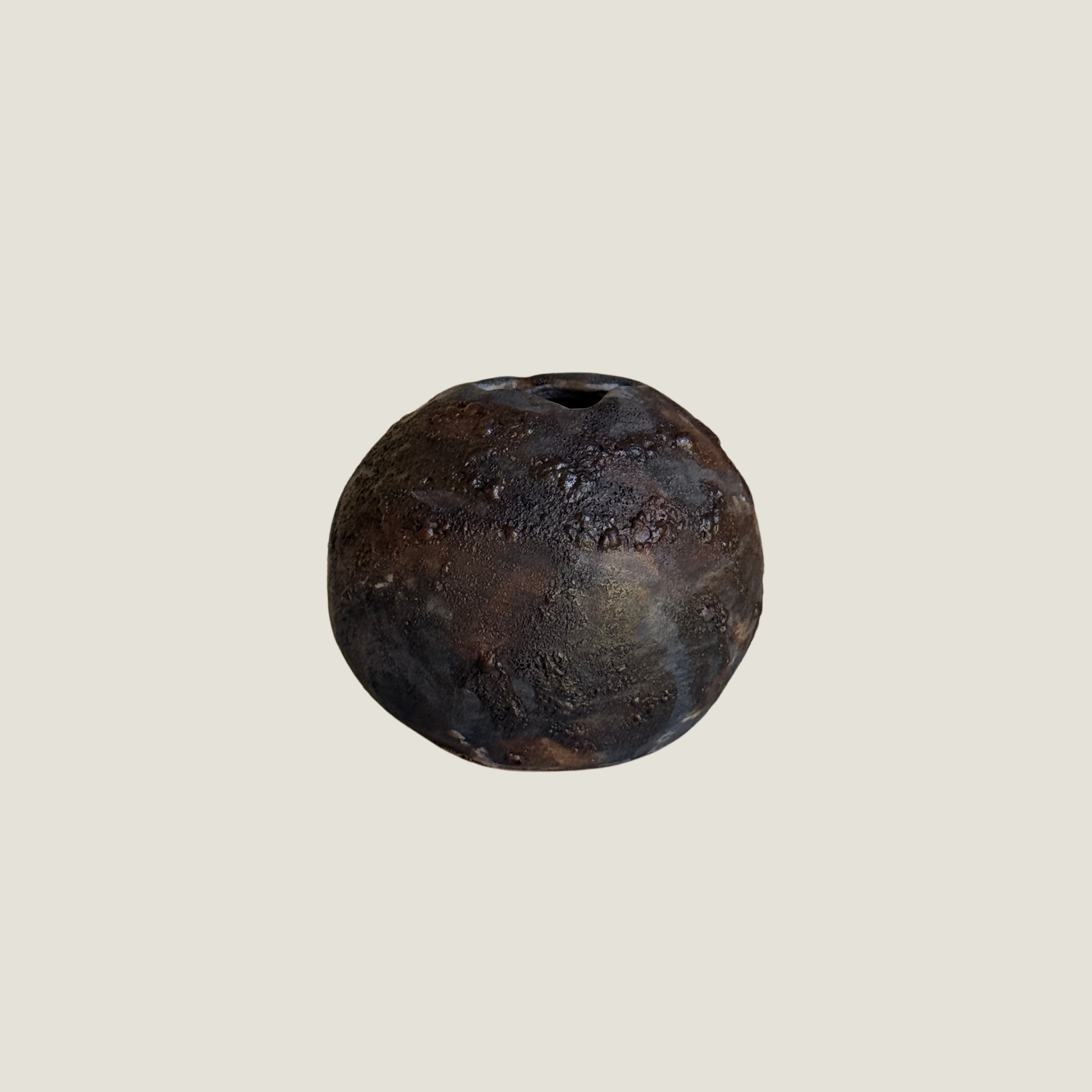 Round dark ceramic moon vase with a textured lava glaze in brown, charcoal, and bronze, and a small opening at the top
