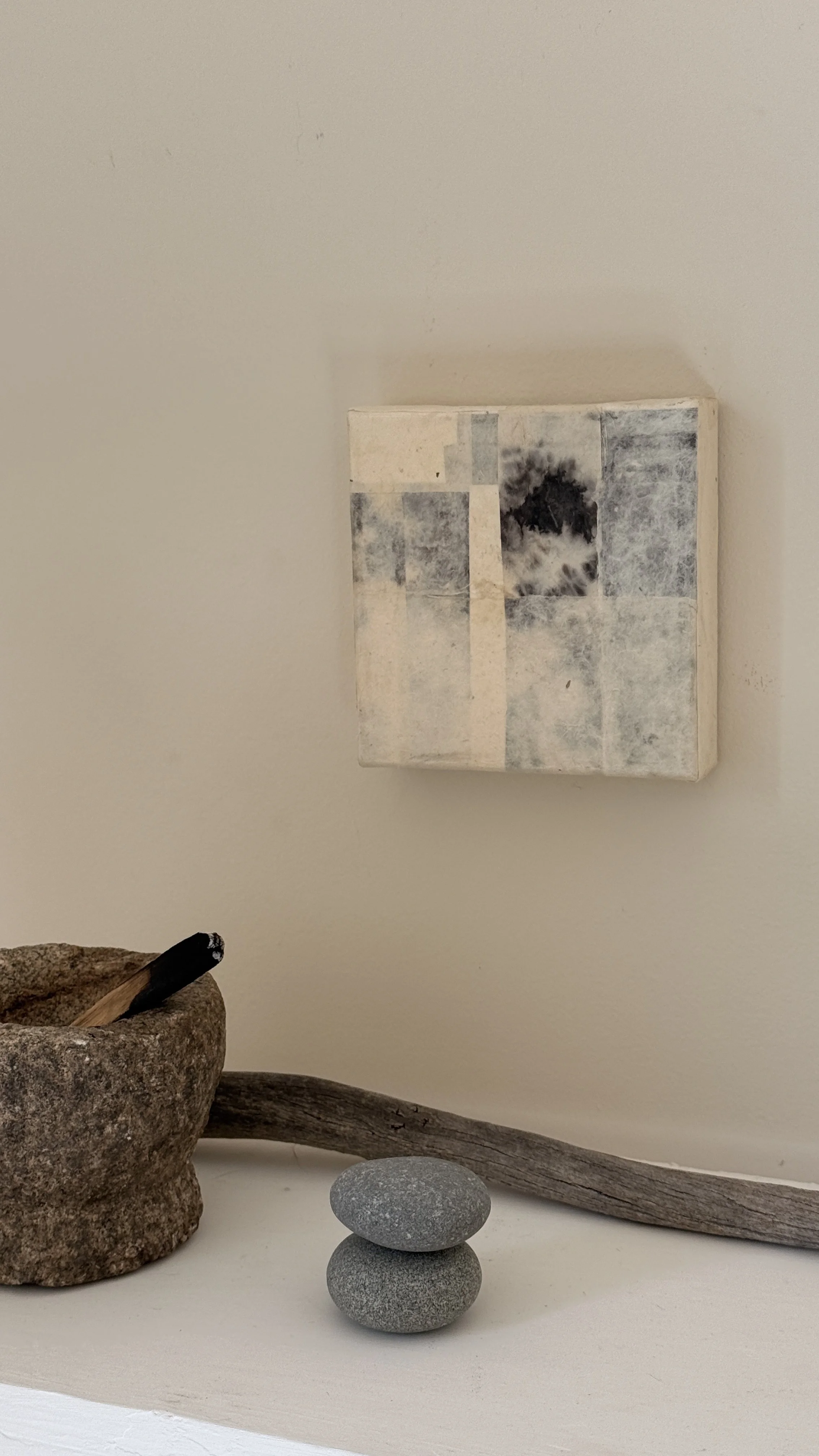 Small abstract collage of layered cream and grey handmade papers with a dark bloom-like mark near the top, unframed 6x6 art