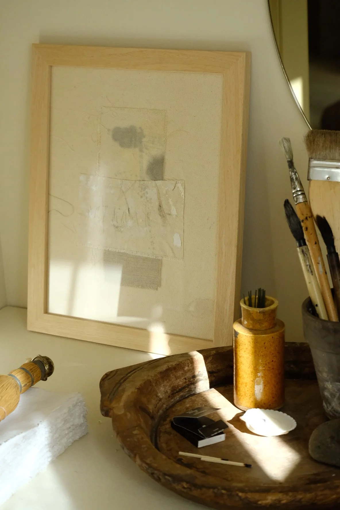 Framed 11 x 14 collage of layered canvas panels and a grey cloth patch with soft grey marks