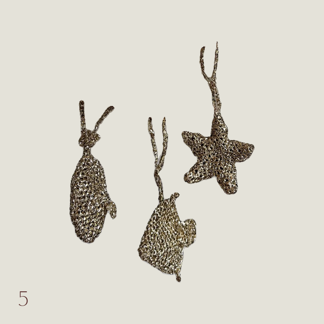 Gold crochet bag charms shaped like a fish and star
