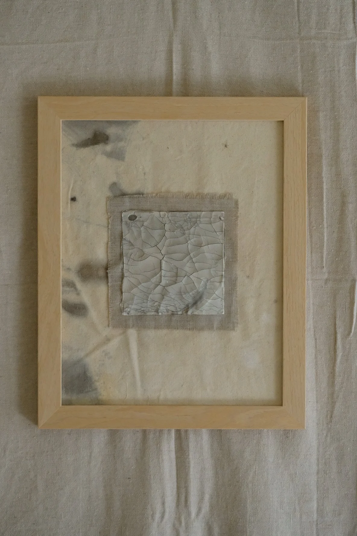 Framed 11 x 14 collage of a crackle paste square on a frayed grey linen patch