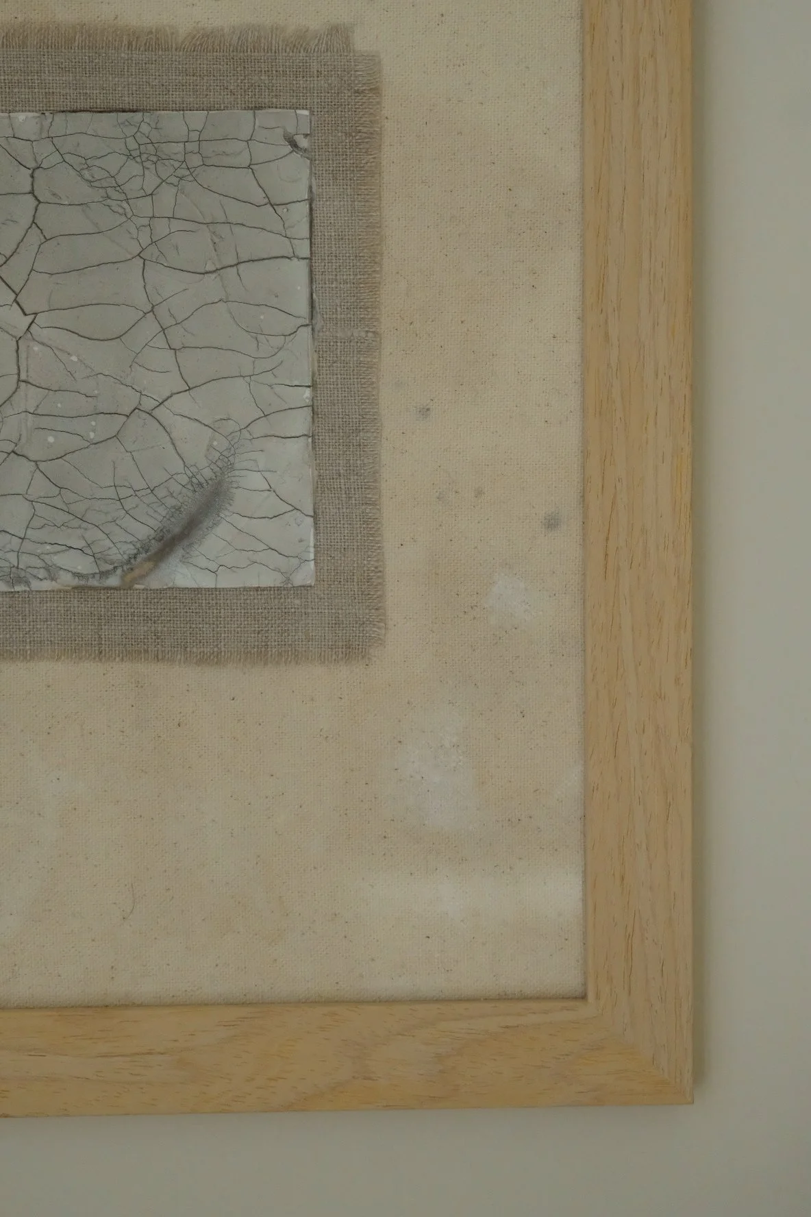 Framed 11 x 14 collage of a crackle paste square on a frayed grey linen patch