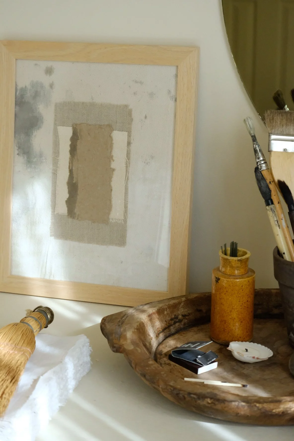Framed 11 x 14 collage of textured brown paper layered over ivory canvas and grey cloth