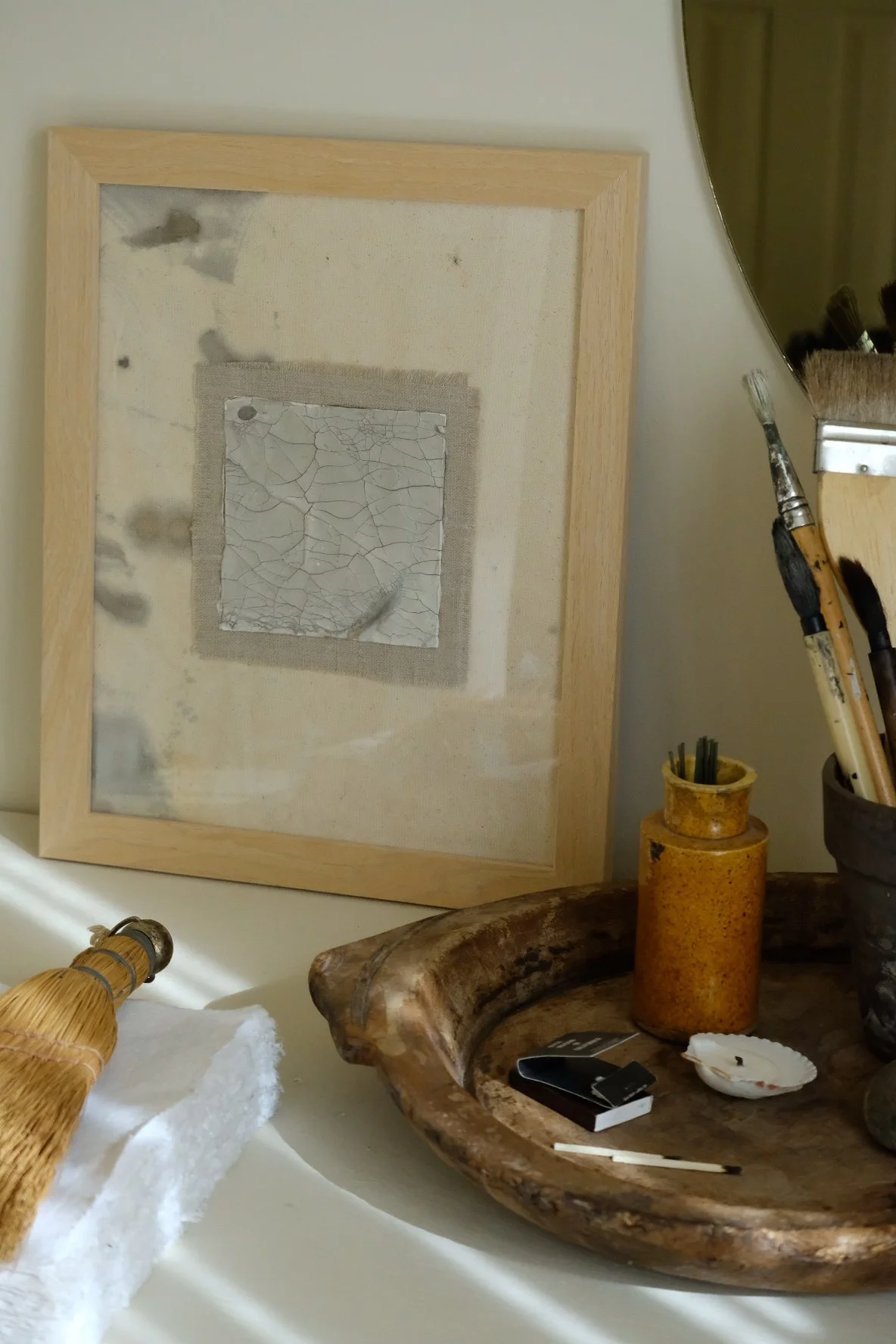 Framed 11 x 14 collage of a crackle paste square on a frayed grey cloth patch