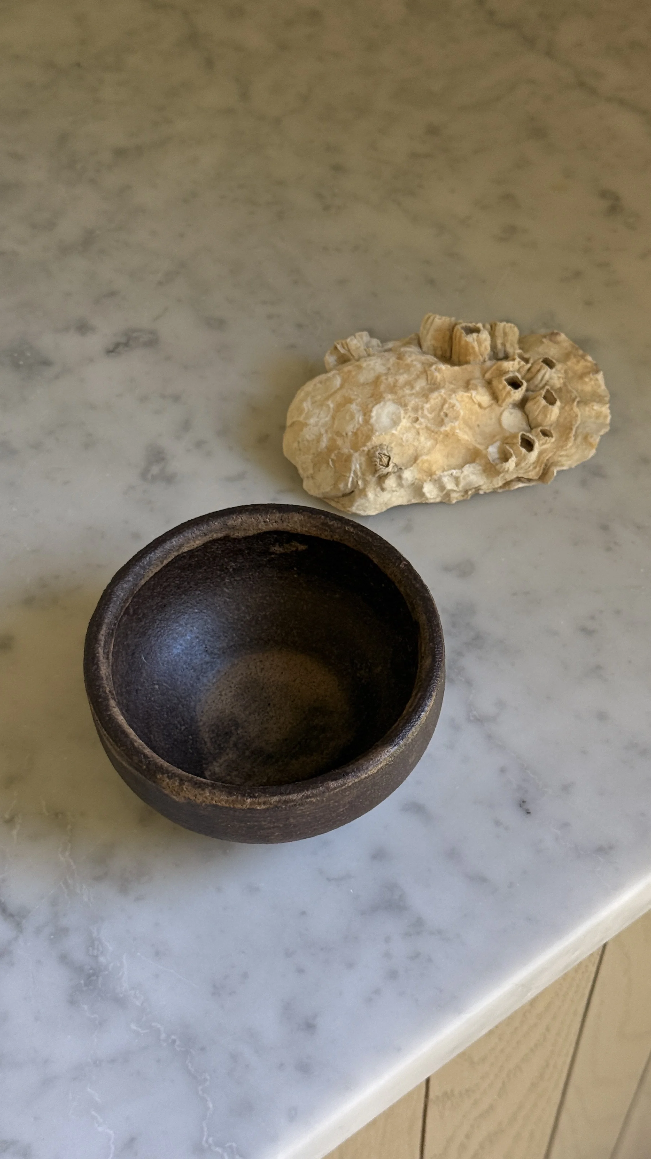 IMG_7024.jpegDark brown ceramic bowl with horizontal brushed texture and warm bronze highlights, tapered base