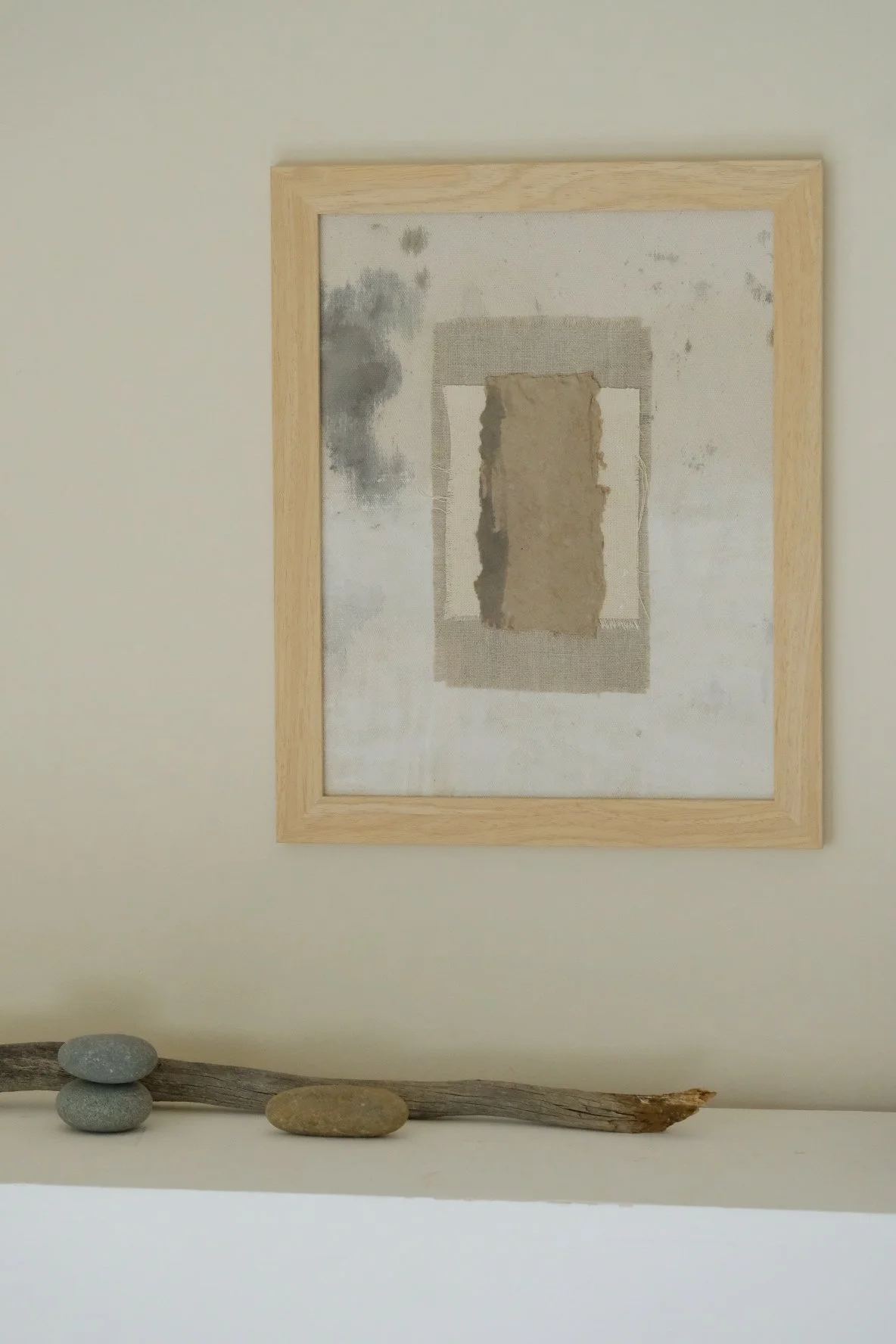 Framed 11 x 14 collage of textured brown paper layered over ivory canvas and grey cloth