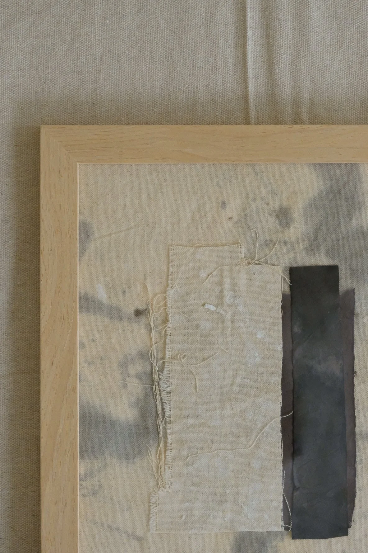 Framed 11 x 14 collage of a cream canvas strip beside a tall charcoal paper strip