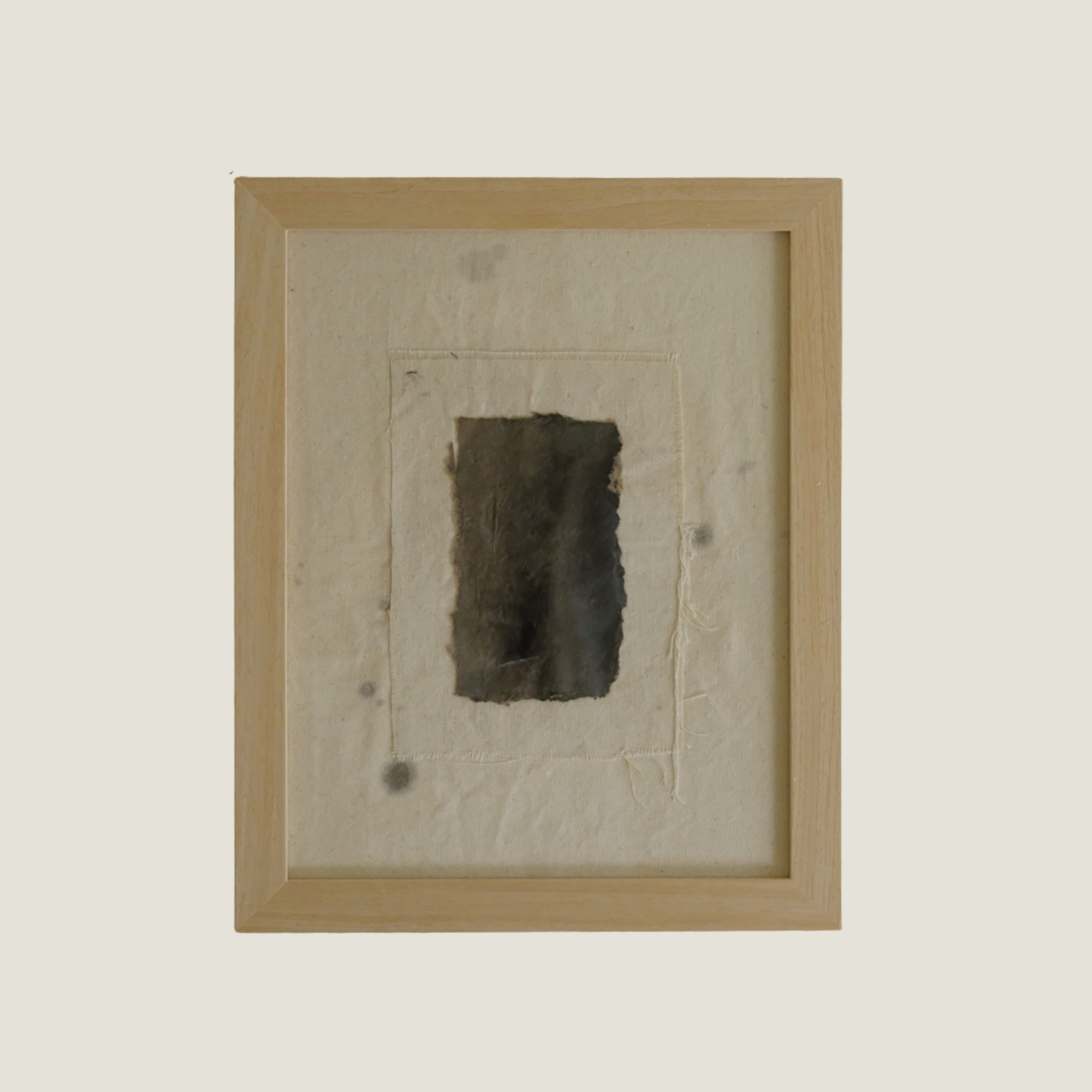 Framed 11 x 14 collage of torn dark paper on a stitched raw canvas panel