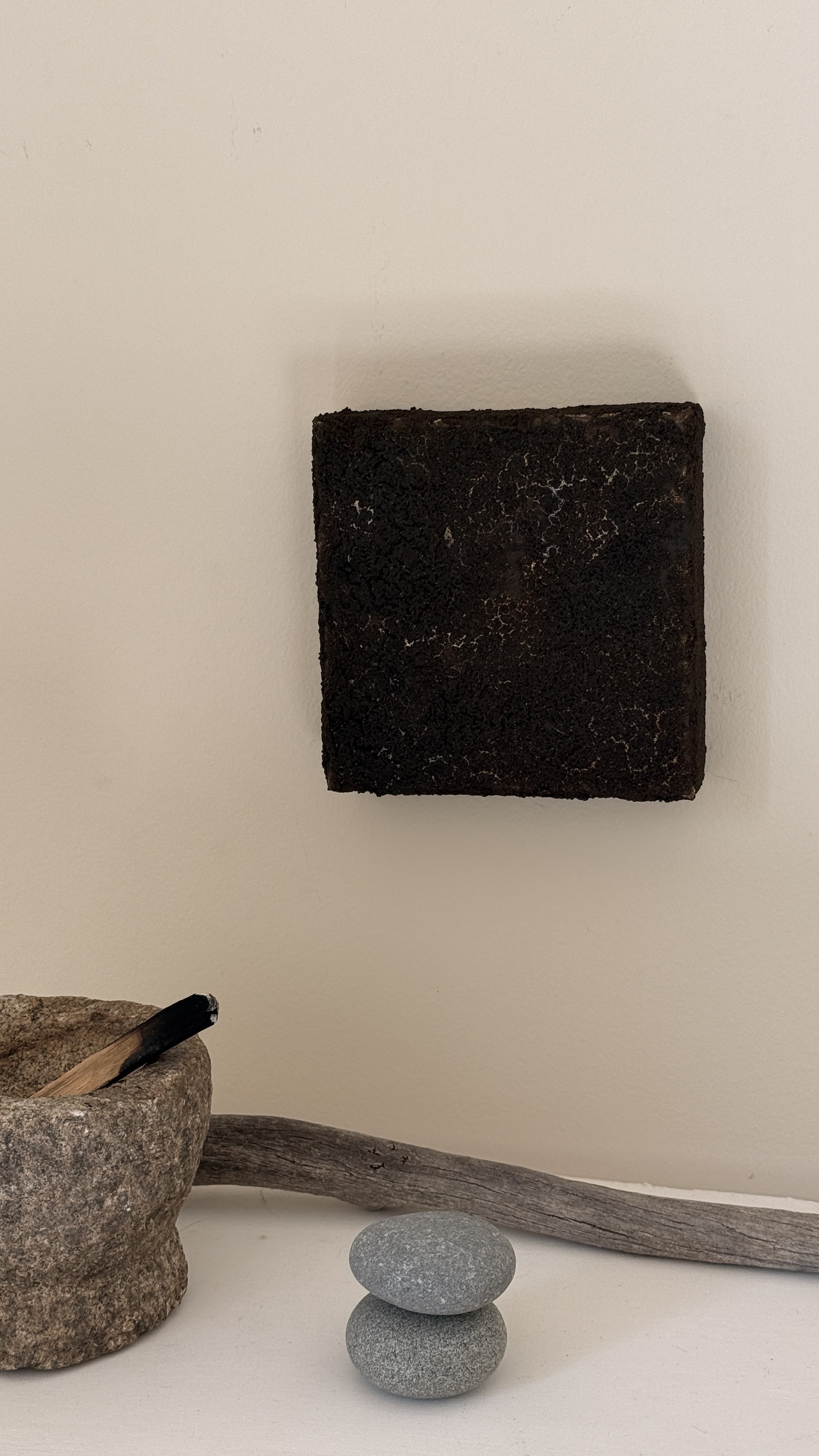 Small abstract artwork with a dense, cracked dark brown and black textured surface and faint pale veining, unframed 6x6 on linen