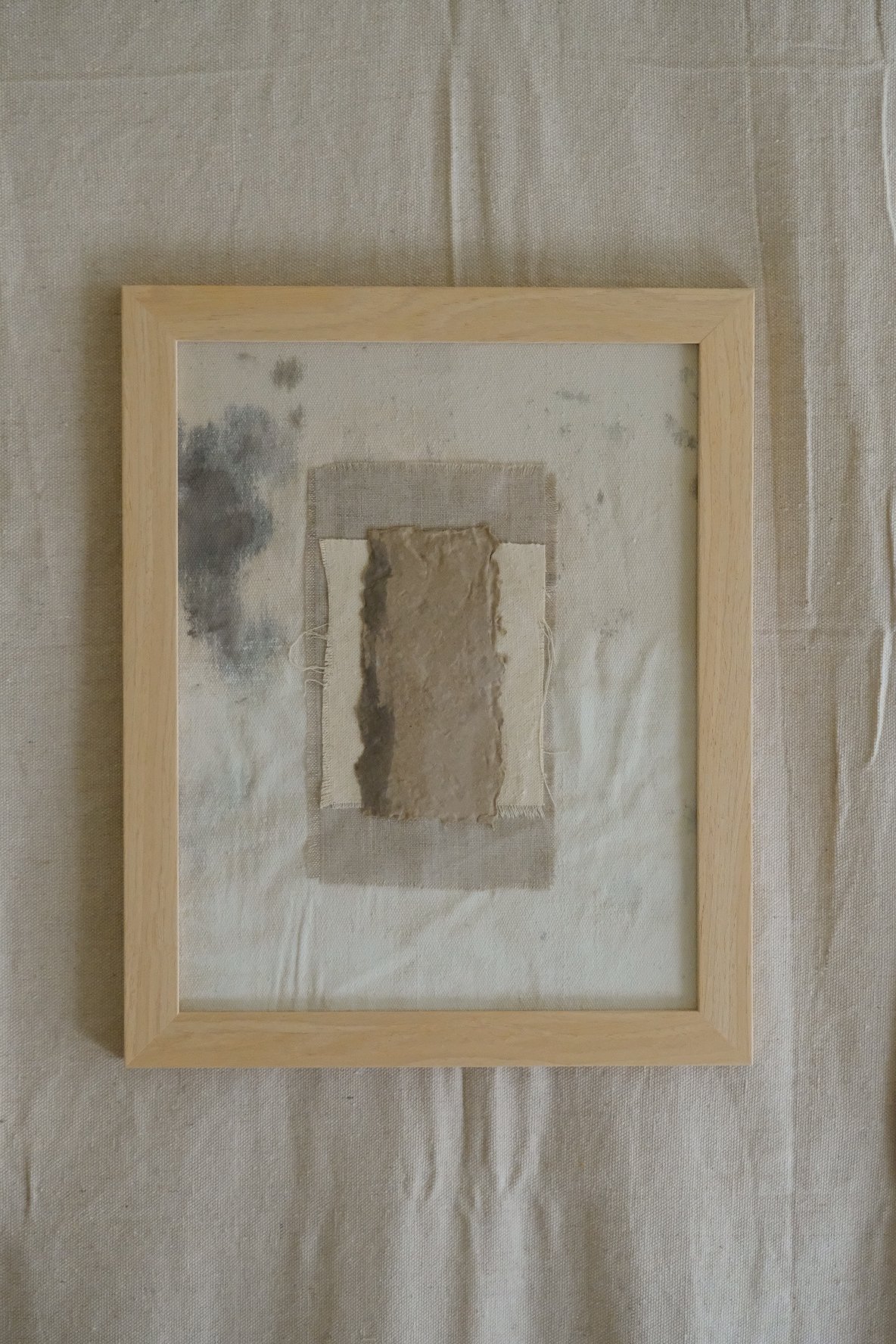 Framed 11 x 14 collage of textured brown paper layered over ivory canvas and grey cloth
