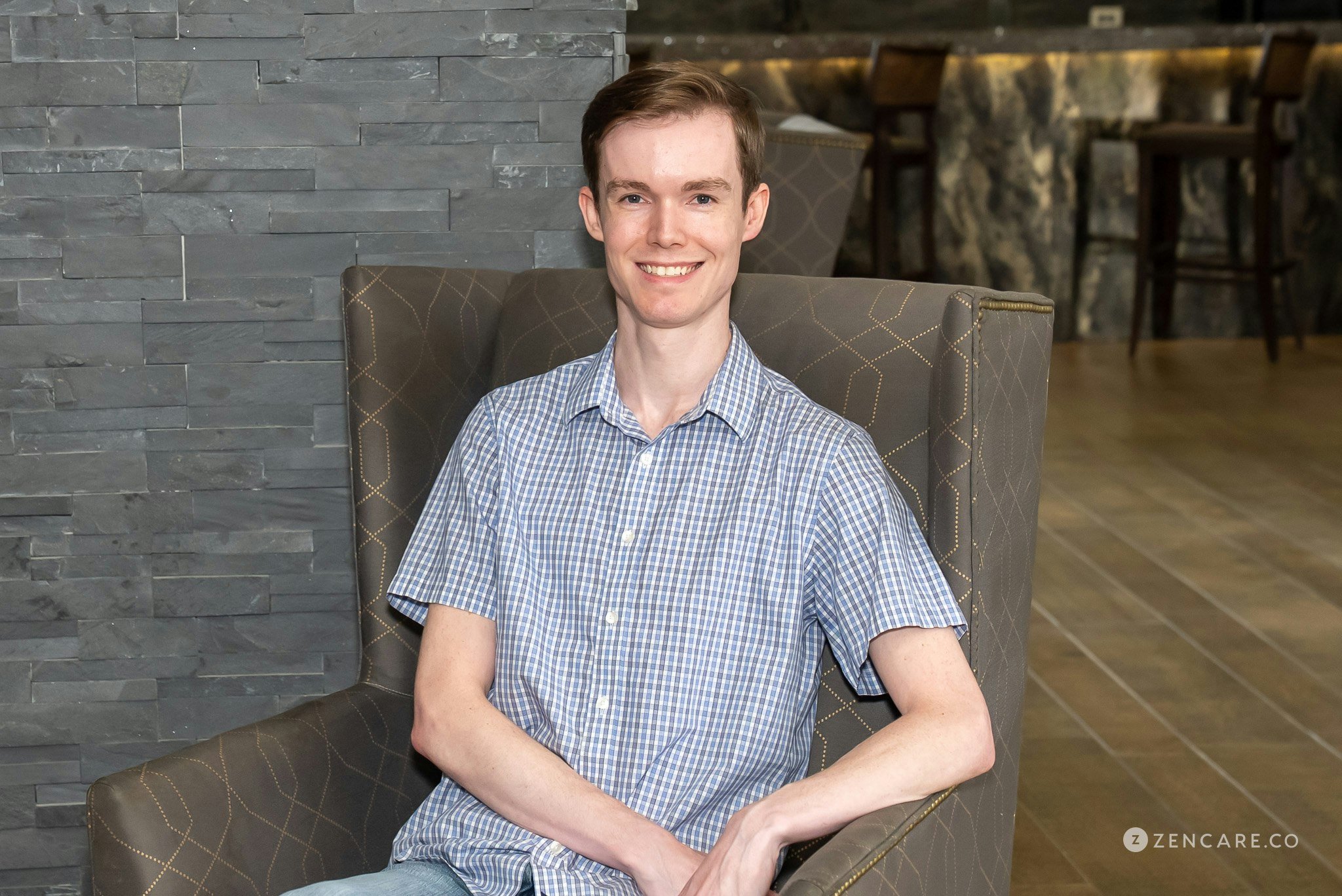 man sitting in chair smiling