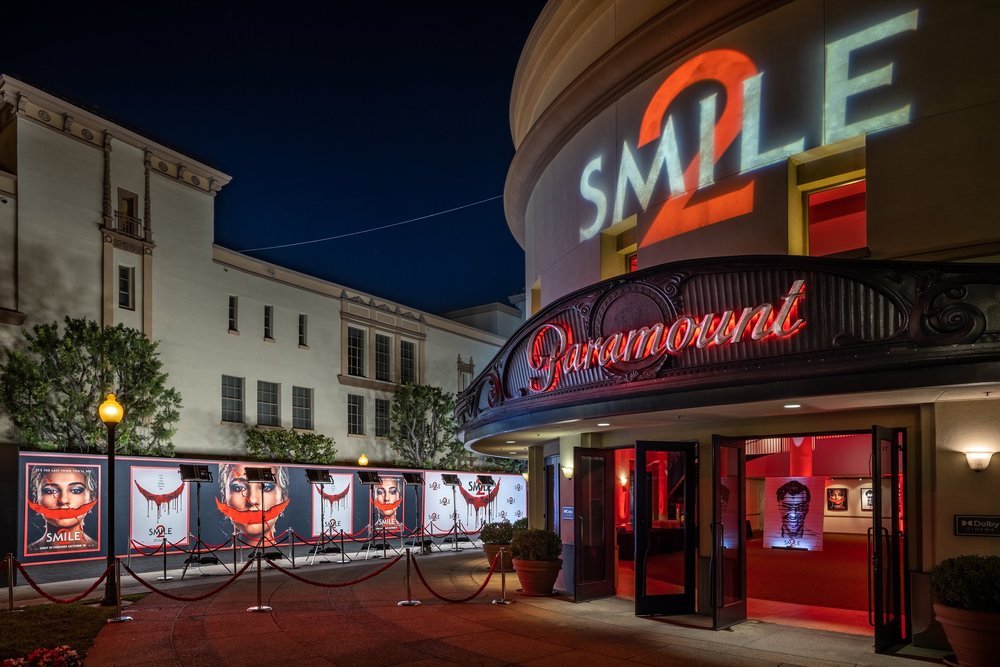 Paramount Pictures entrance at night with "SMILE 2" projection and red carpet