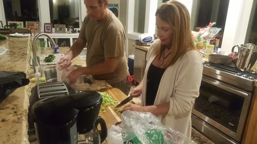 Guests preparing a meal together in the Hilltop House kitchen at Baxter Ranch, enjoying a comfortable cooking space designed for shared meals and mountain retreats.