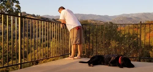 Quiet moments at Hilltop House, where guests can unwind on the balcony, enjoy sweeping mountain views, and experience the peaceful beauty of Baxter Ranch.
