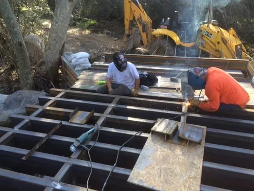 The Creekside Yurt patio at Baxter Ranch taking shape during construction, as builders craft the outdoor space designed to connect guests with the surrounding forest and natural landscape.