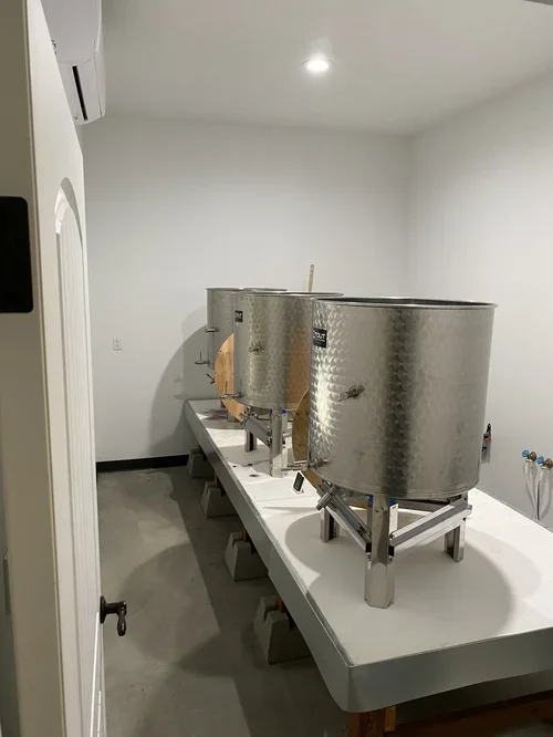 Stainless steel wine processing tanks used at Baxter Ranch for handcrafted wine production, showcasing the equipment behind the vineyard-to-bottle process.