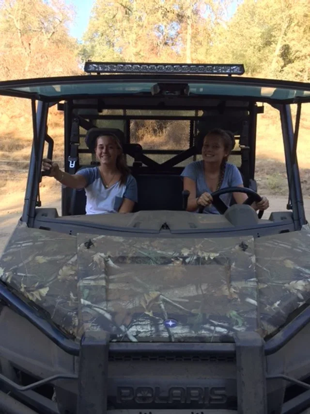 During the early development of Baxter Ranch, family members explore the property by off-road vehicle, experiencing the rugged landscape and natural beauty that inspired the mountain retreat.