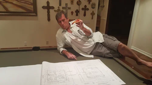 Baxter Ranch owner taking a moment to review architectural plans during the creation of the property, capturing the early vision and craftsmanship behind the mountain retreat.