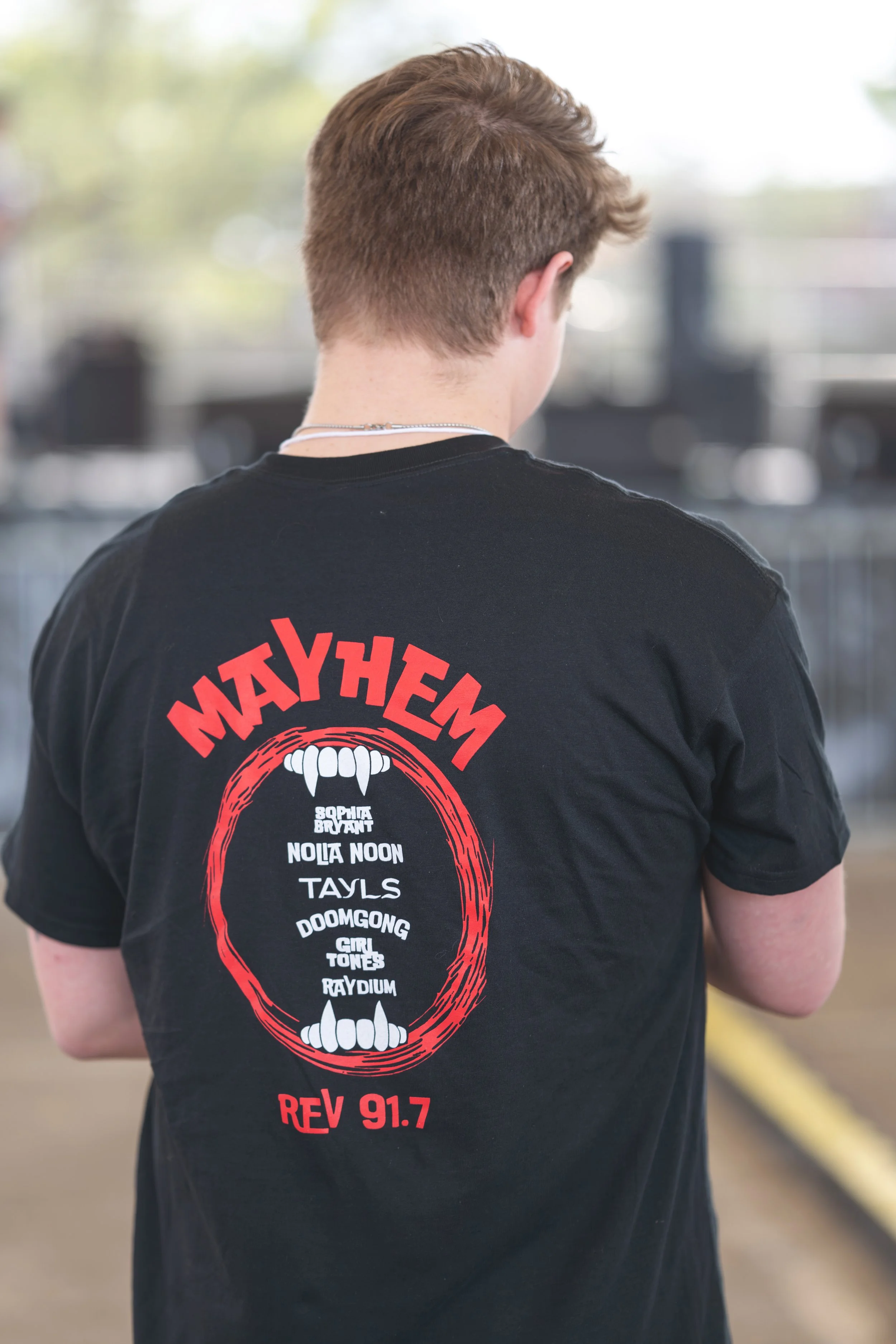 Back of a person wearing the official Mayhem 2026 T-shirt.