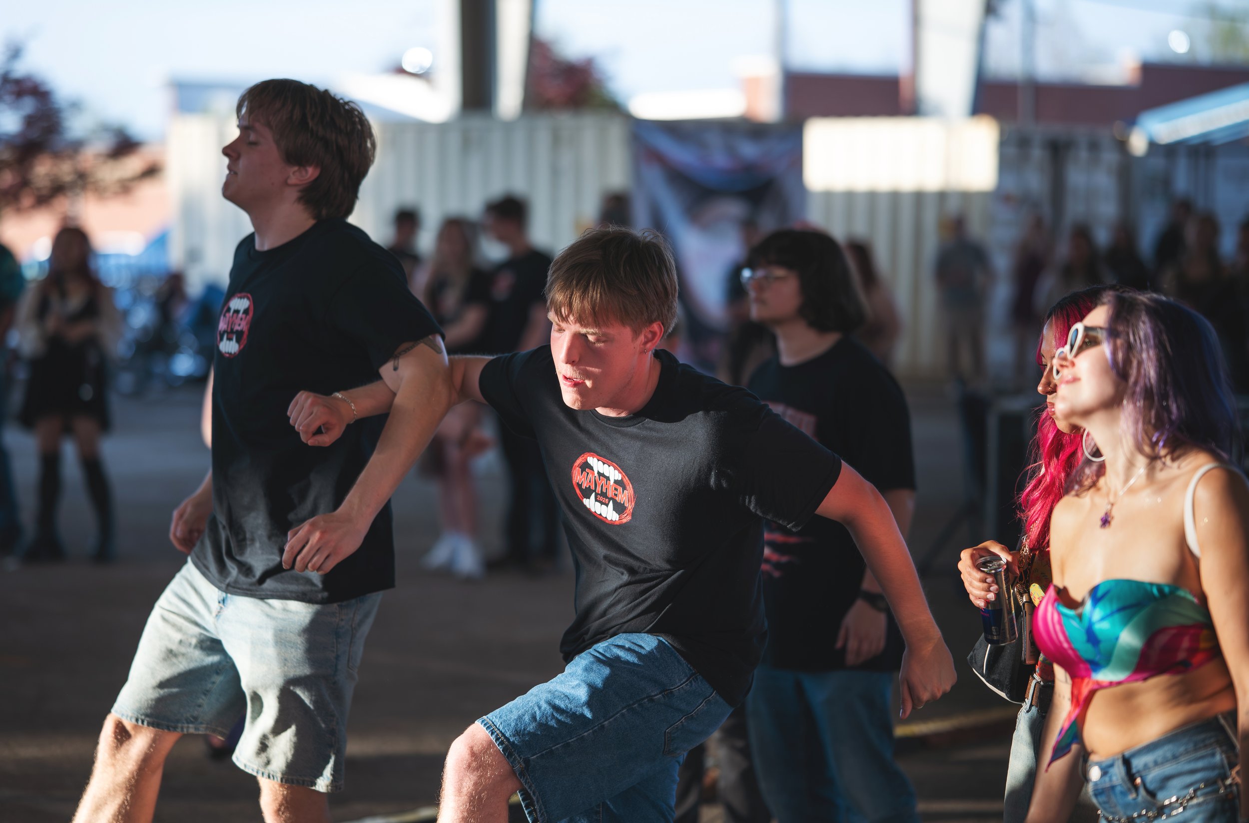 Young people participating in a dance or conga line at the Mayhem music festival in Bowling Green, Kentucky.