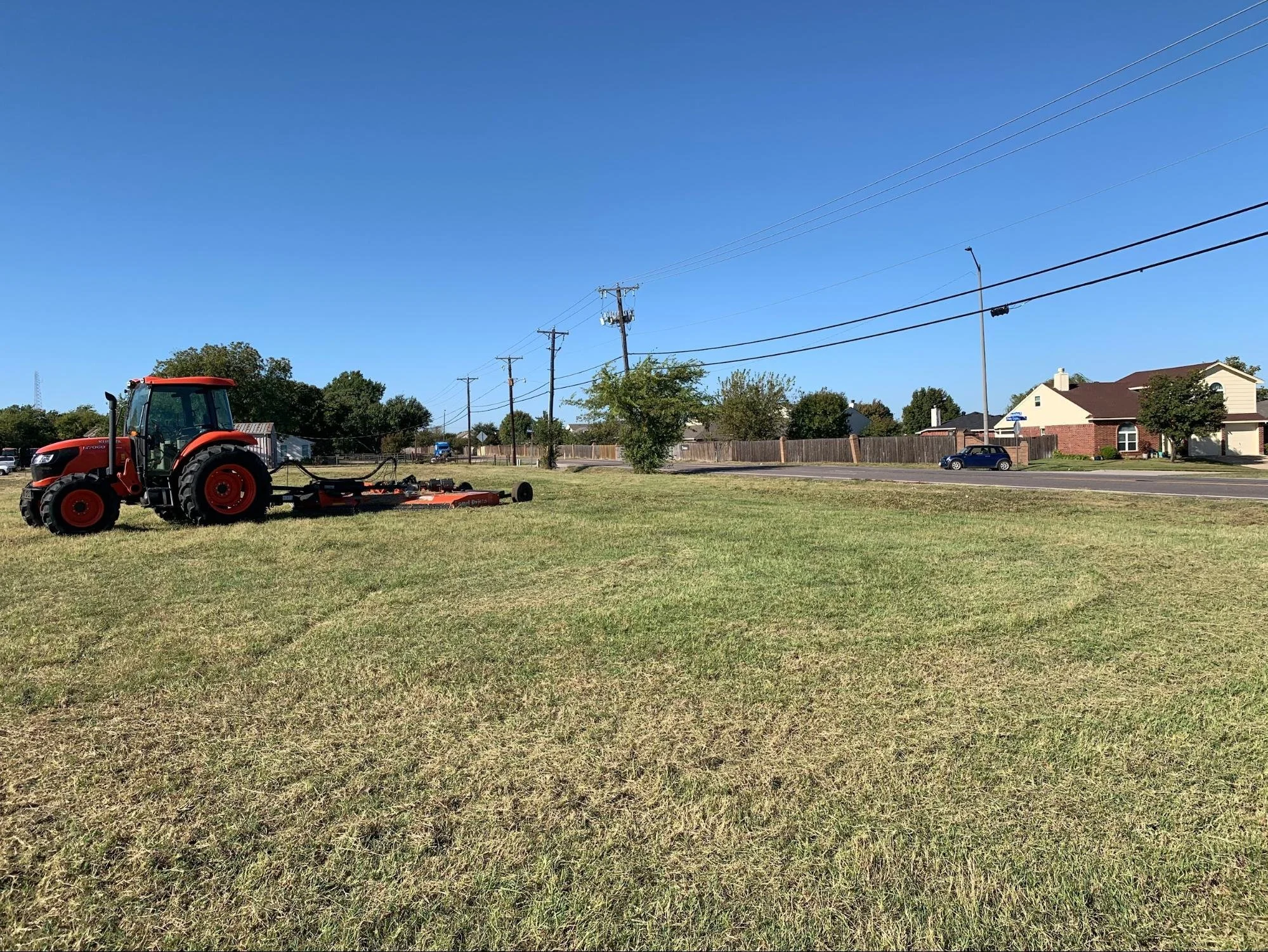Tractor mowing the field of a Dallas, Texas municipal property