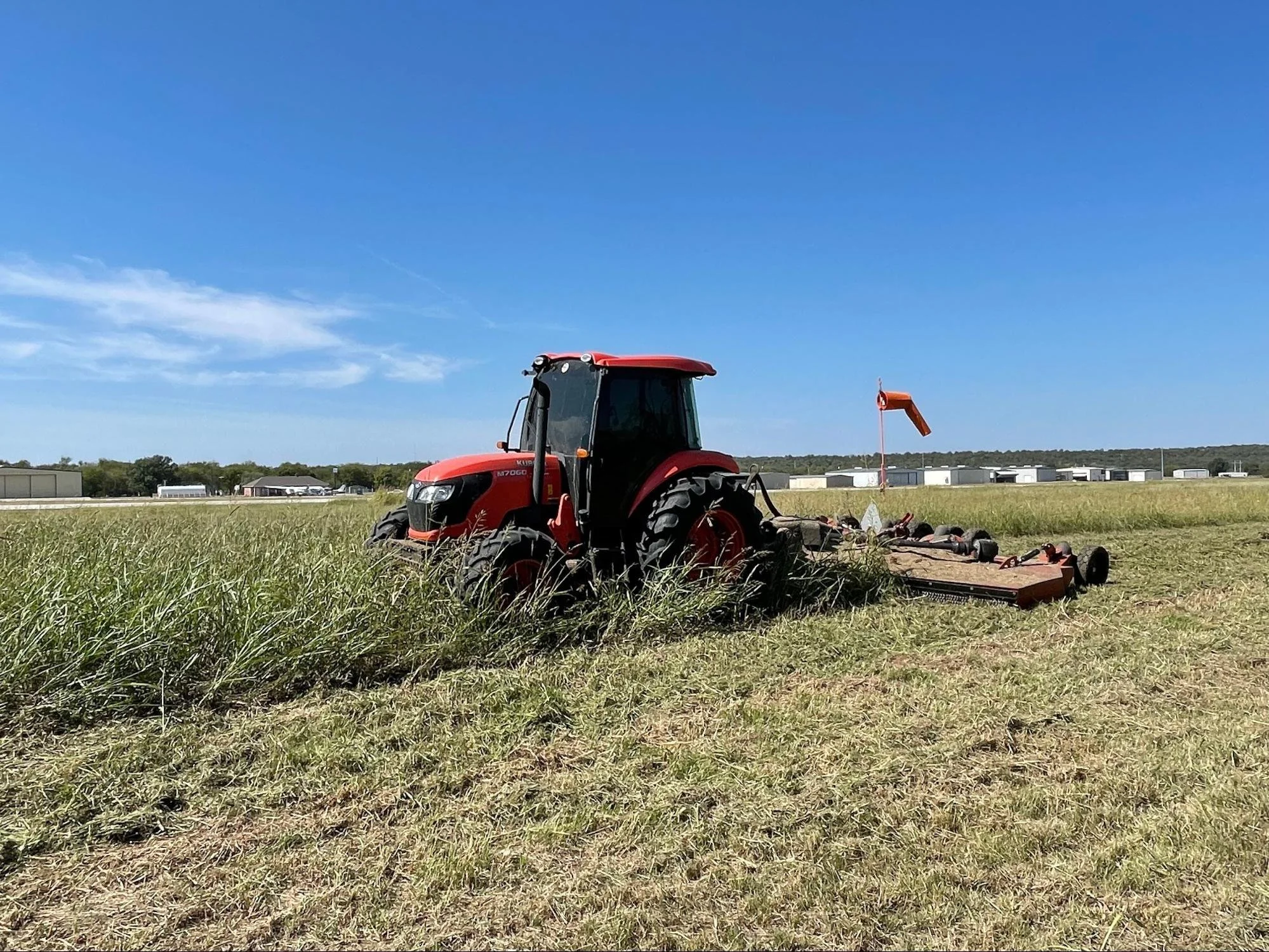 Tractor mowing the Acreage of a White Settlement, TX airfield
