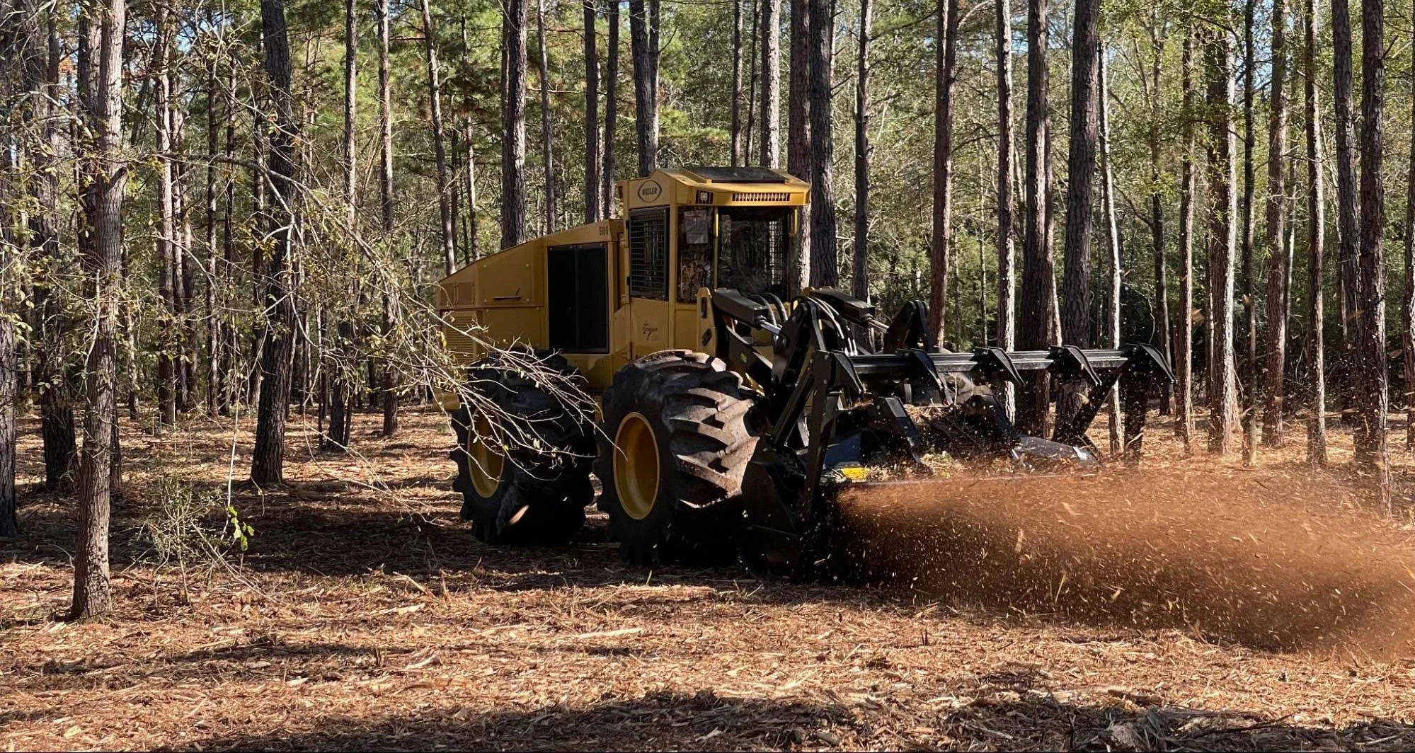 Bulldozer and excavator clearing open ranch land during a Weatherford, TX, land cleaning project.