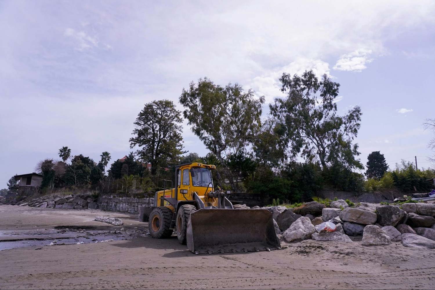 Tractor performing land demolition for concrete foundation