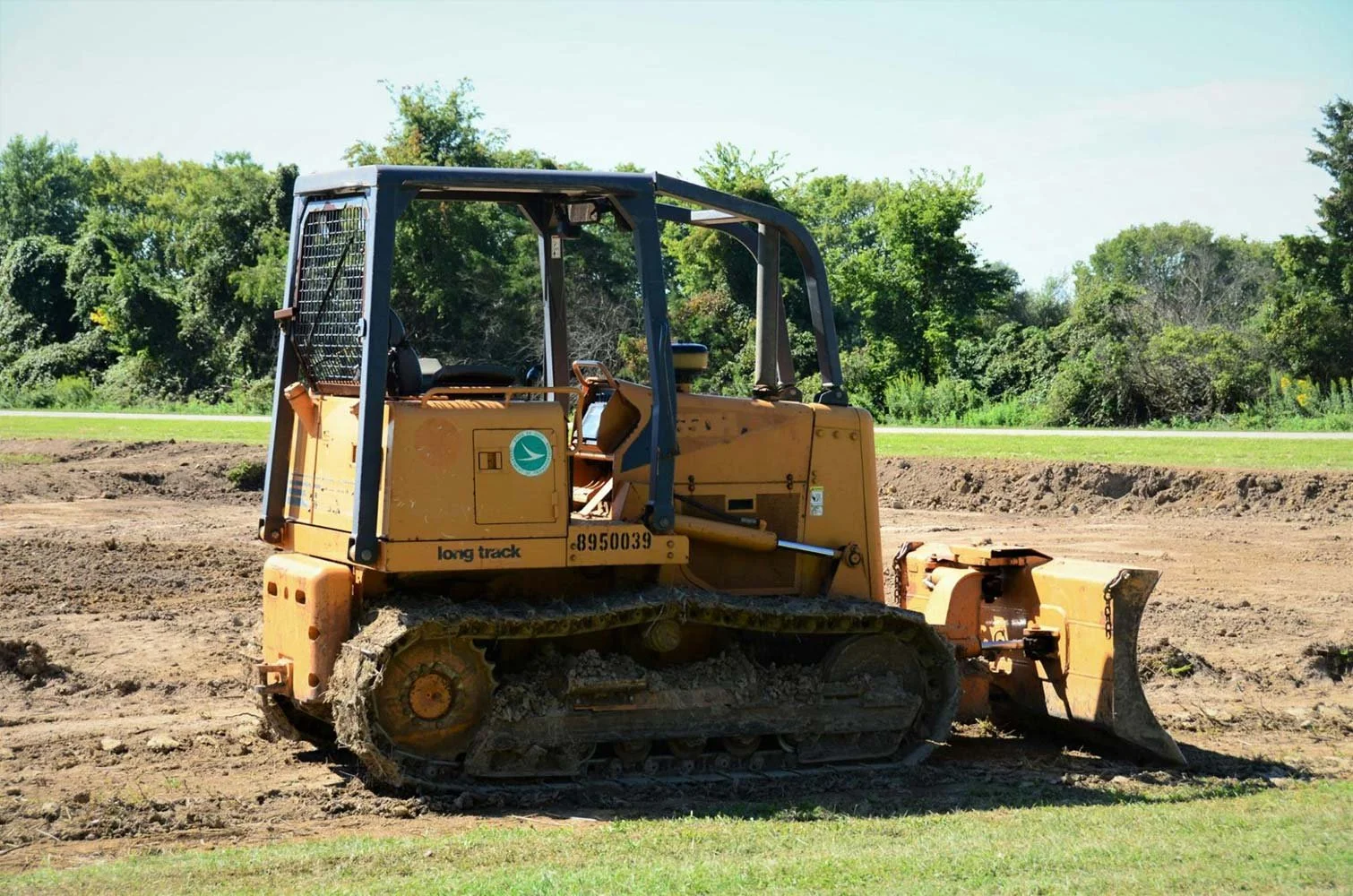 Bulldozer preparing rocky terrain for land Improvement