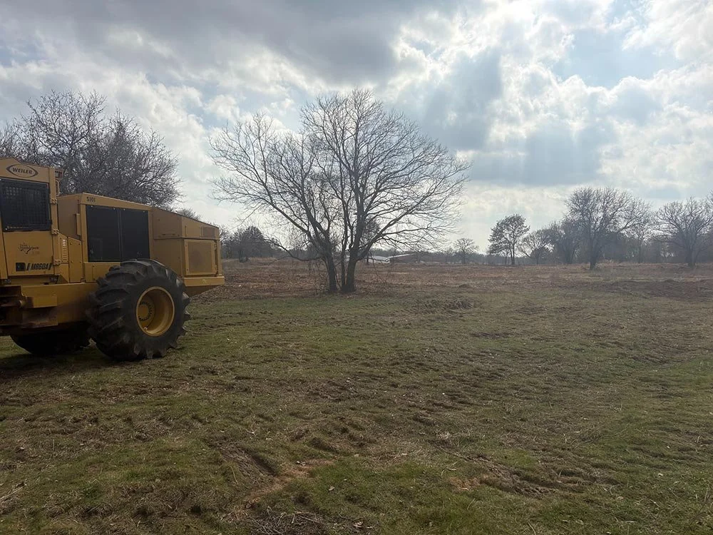 Open land in need of development and a large piece of machinery
