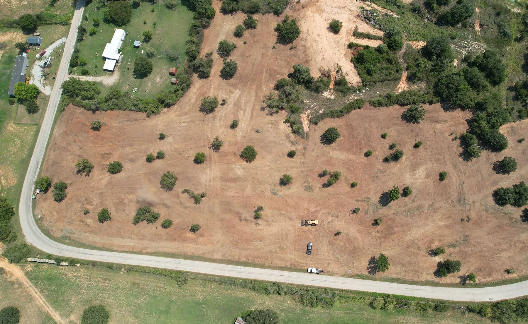 An overhead view of a cleared section of land in summer