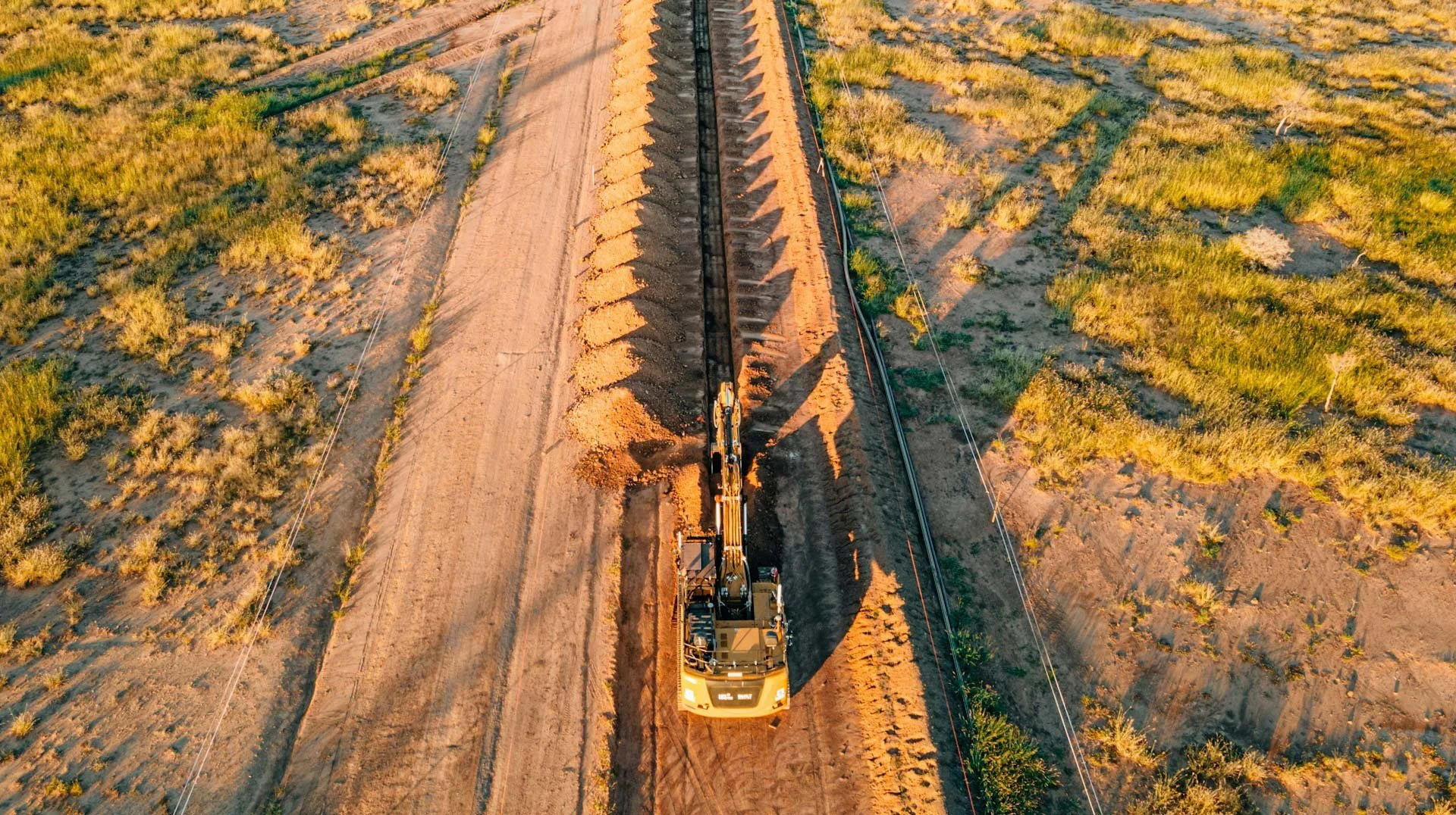 Excavator prepares trenches for pipeline ROW clearing