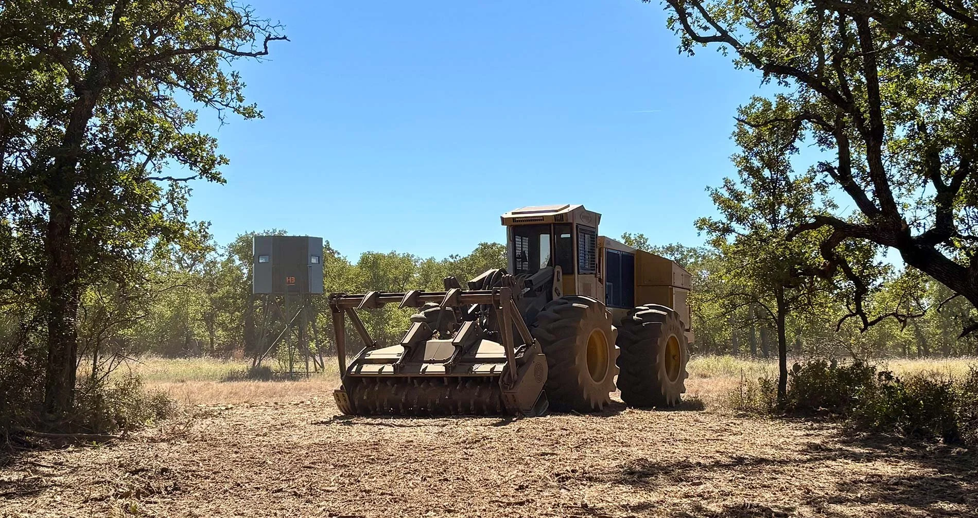 Land clearing machinery with a hunting blind in the background
