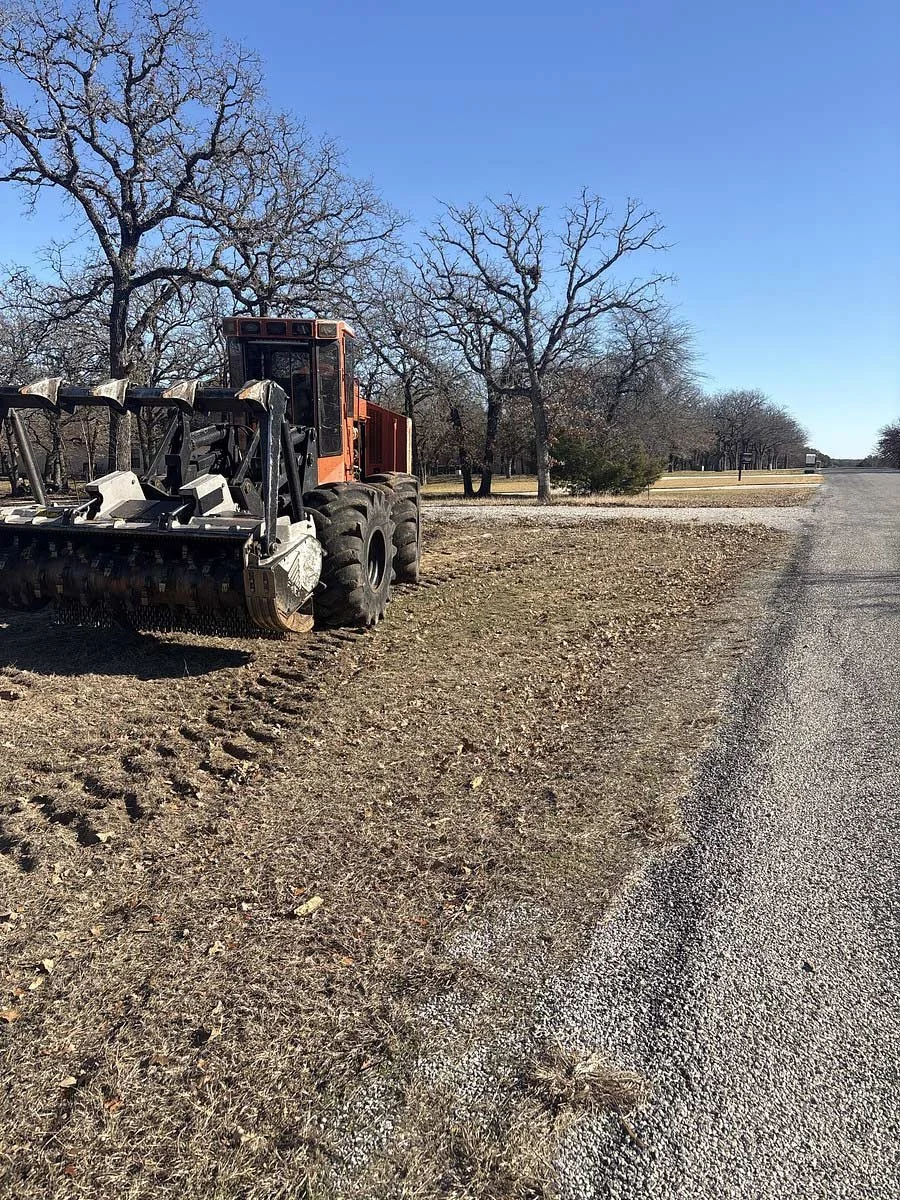 Large land clearing machinery in a rural residential area