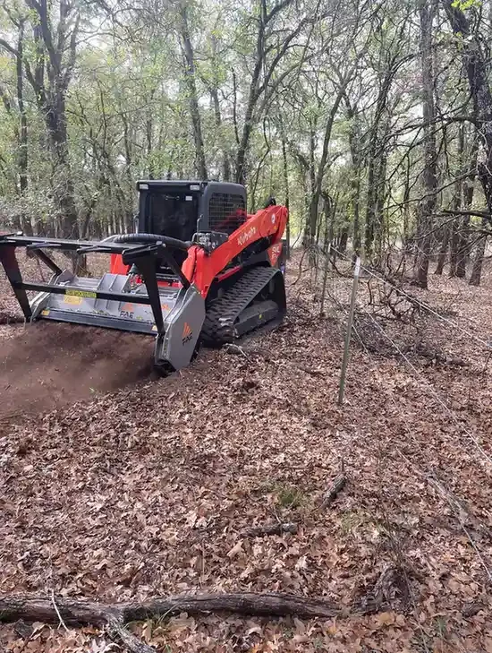 Skid-steer mowing around trees