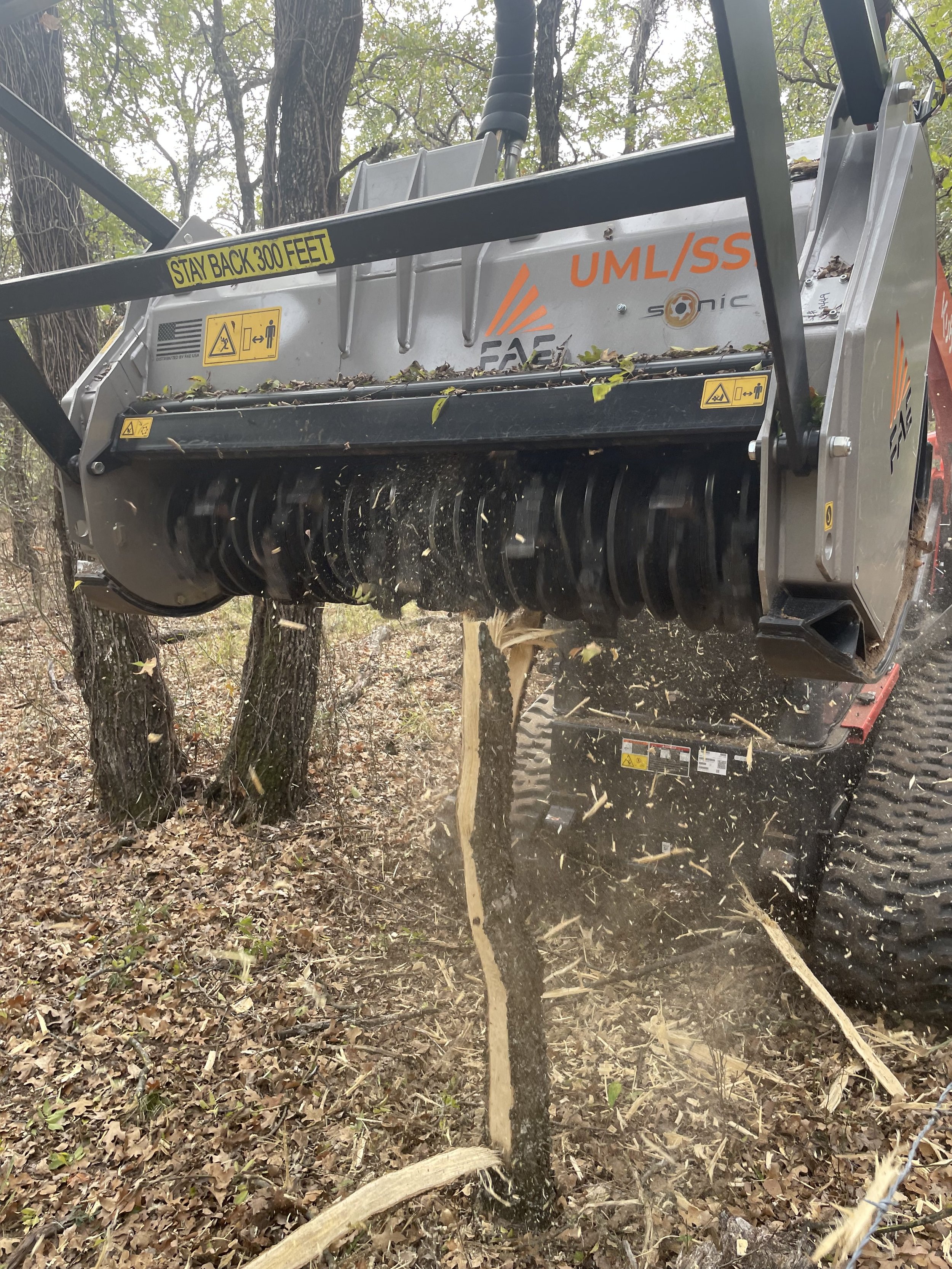 Skid-steer milling down tree