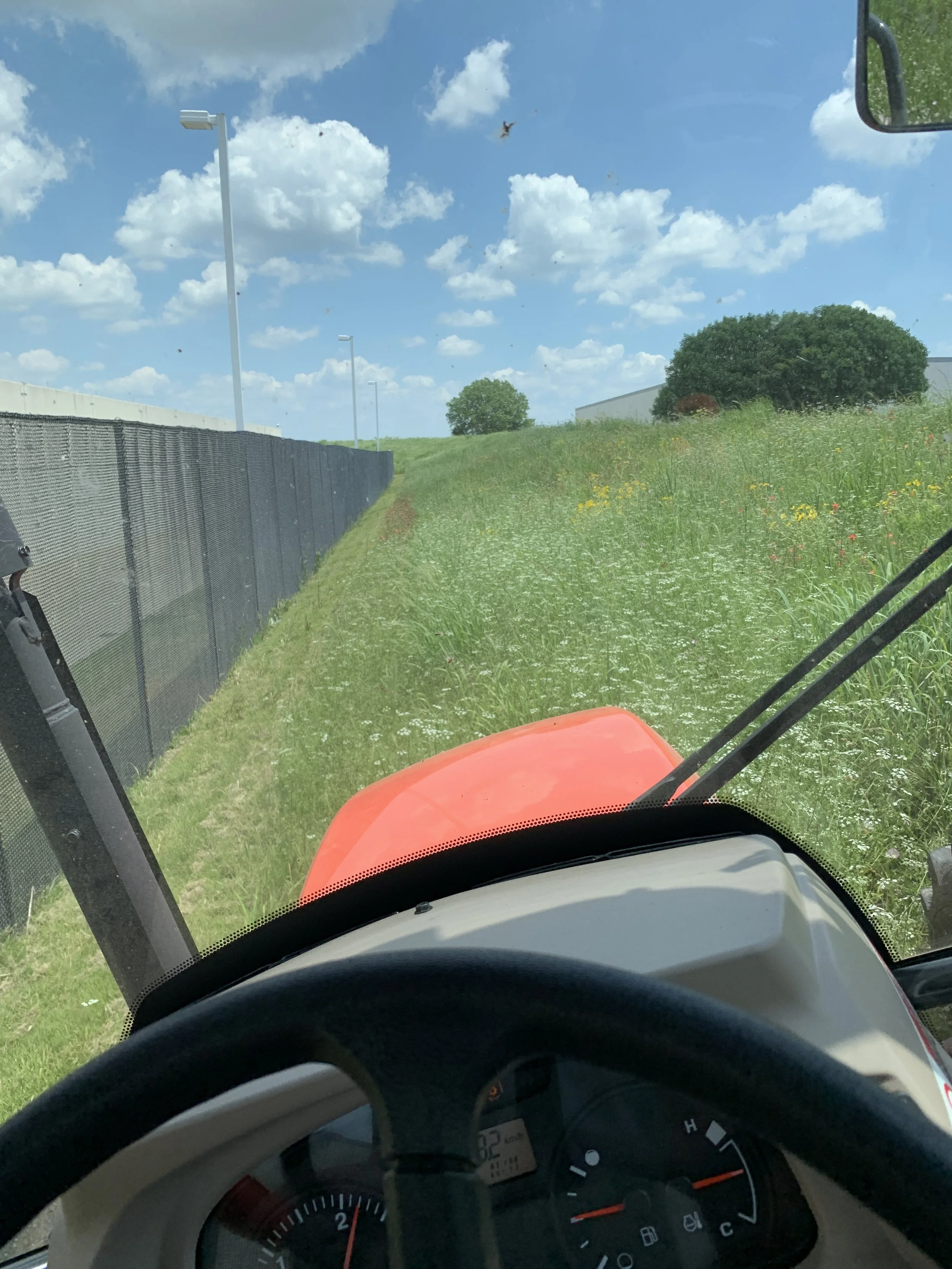 Tractor mowing on green hill 