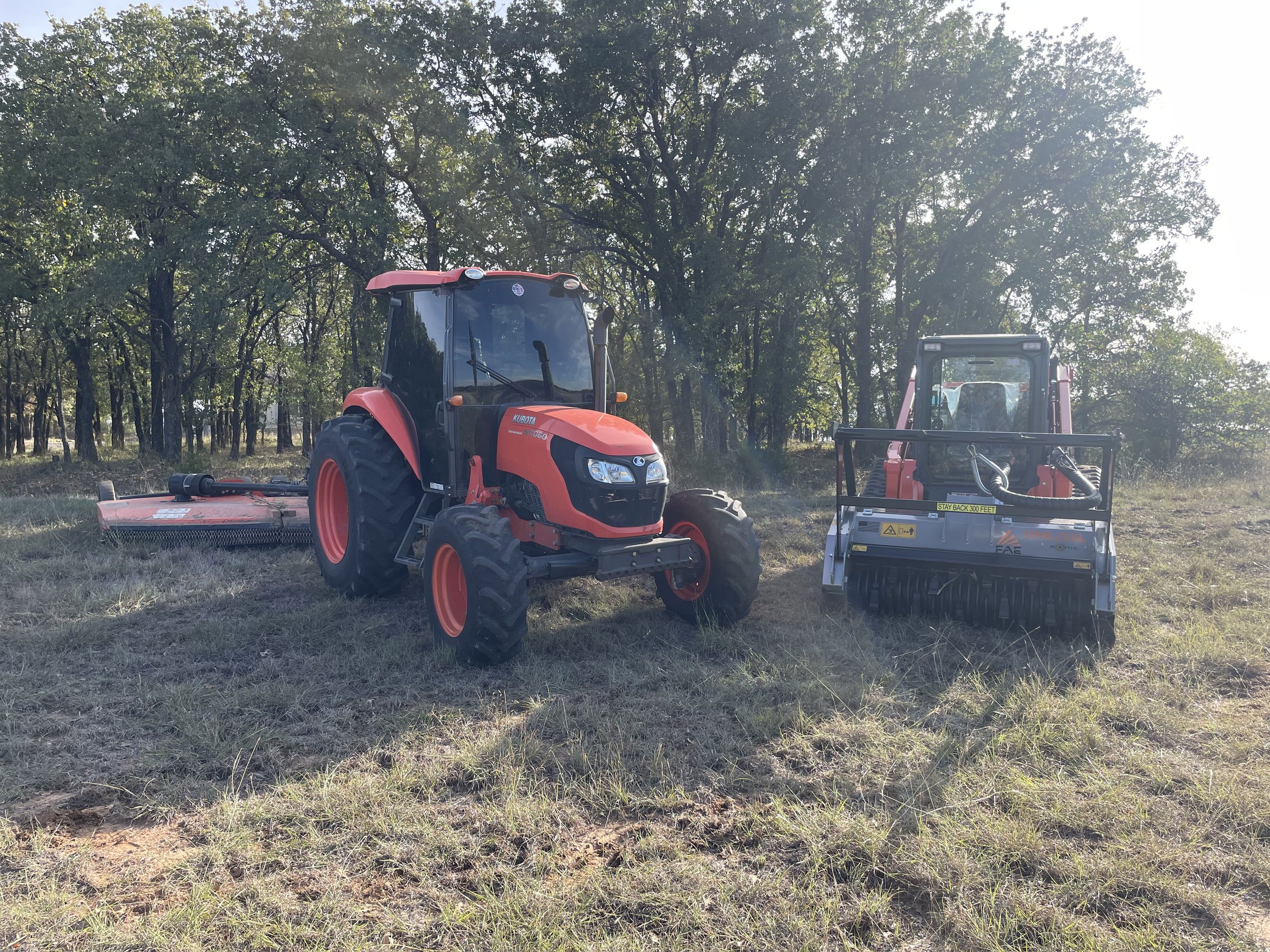 Tractor and Skid-steer side by side on a field