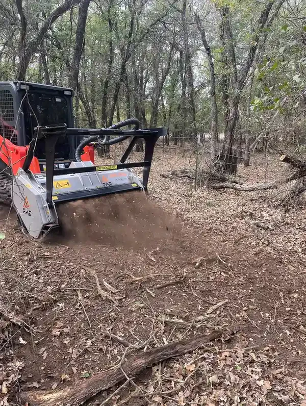 Skid-steer mowing around trees