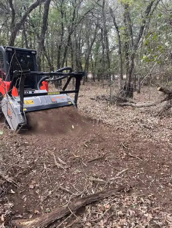 Skid-steer mowing around trees