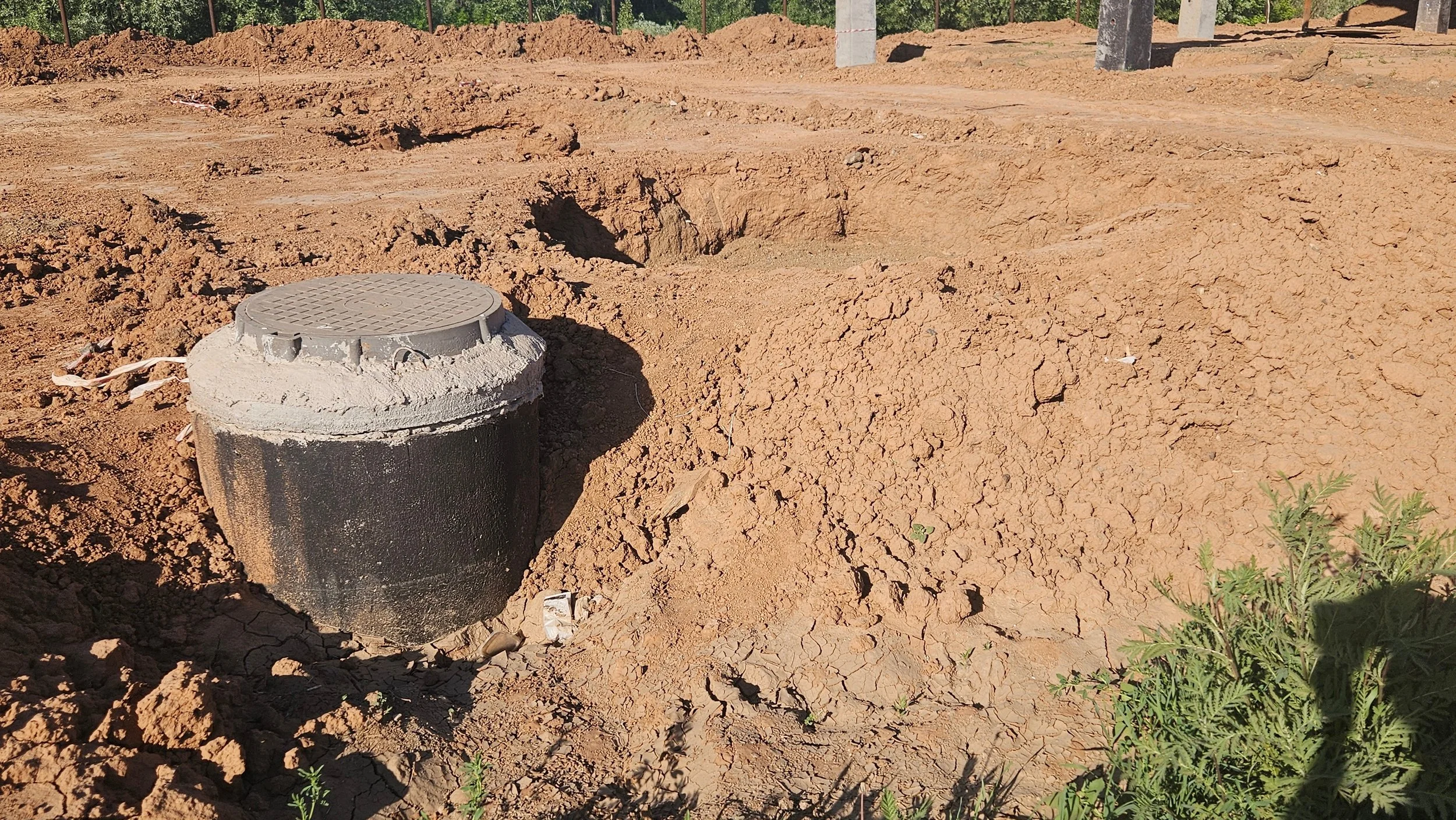 A cleared residential lot where sewer infrastructure has just been installed