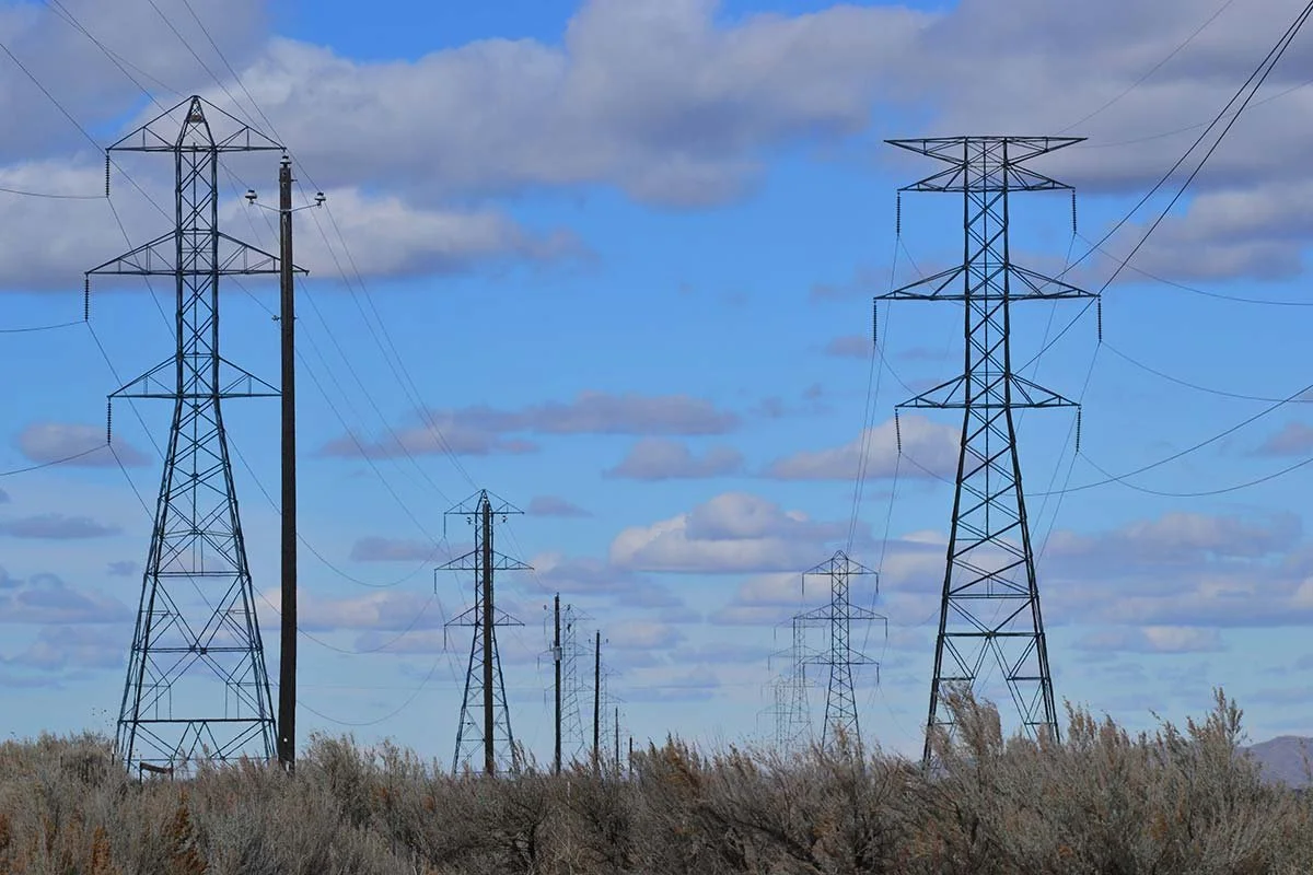 Powerlines and infrastructure stretching into the distance on rural land
