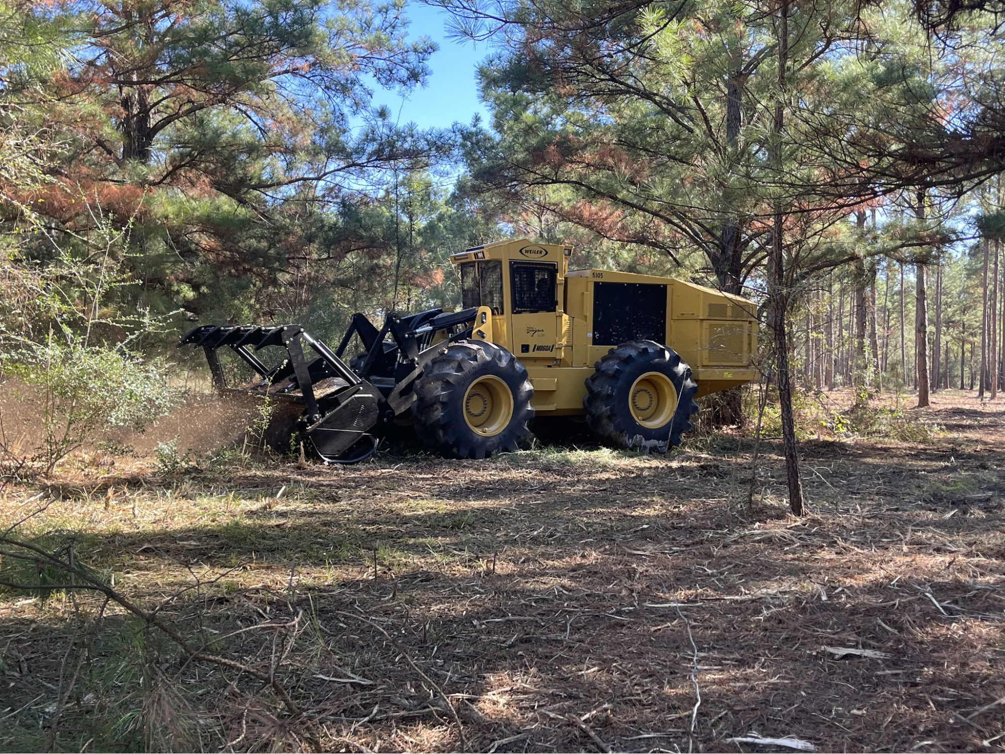 A 5K Land forestry mulcher processes brush on a Texas property