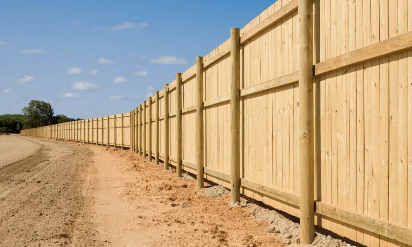 Wood privacy fence with a cleared fence line and open access along the property boundary