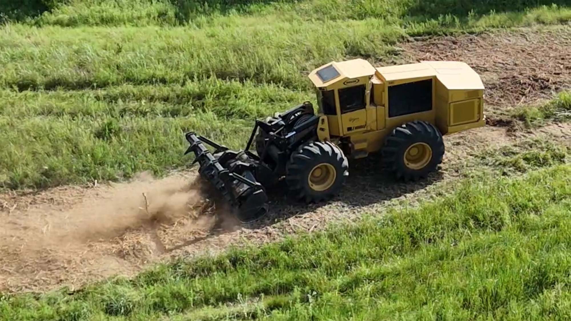 yellow land clearing machinery in operation