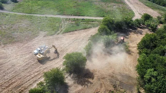 An overhead view of land clearing equipment working large acreage