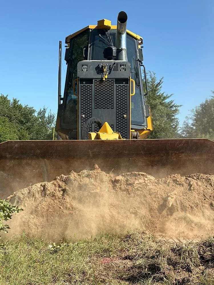 A head-on view of a dozer pushing soil
